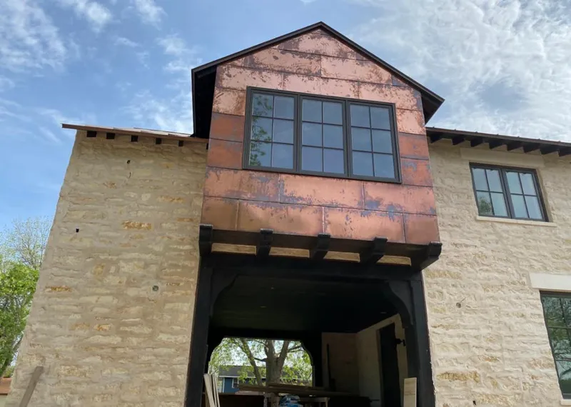 Copper metal panel facade on a stone building for Skylight Installation in Burnsville