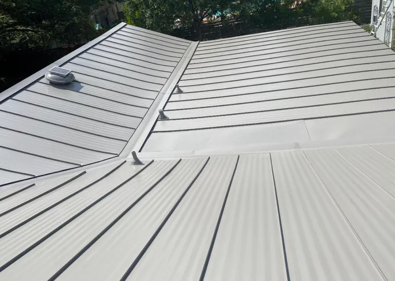 Solar attic fan installed on a metal roof for Roof Ventilation in Burnsville